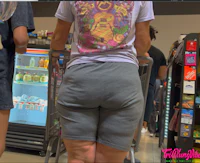 a woman is standing in a grocery store