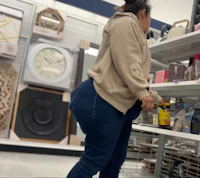 a woman in jeans standing in a store