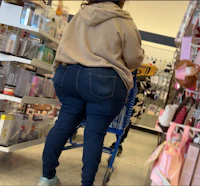 a woman in blue jeans shopping in a store