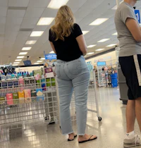 a woman and a man standing in a grocery store