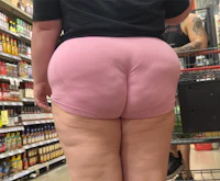 a woman in a pink bikini standing in a grocery store